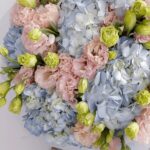 Pastel Sky — powder blue hydrangeas and delicate lisianthus in shades of lime and blush